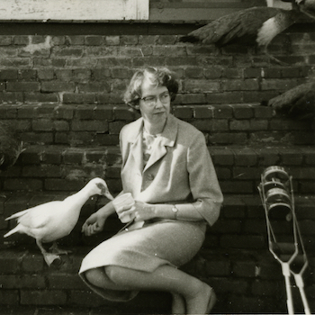 Flannery OConnor with Duck and crutches on steps